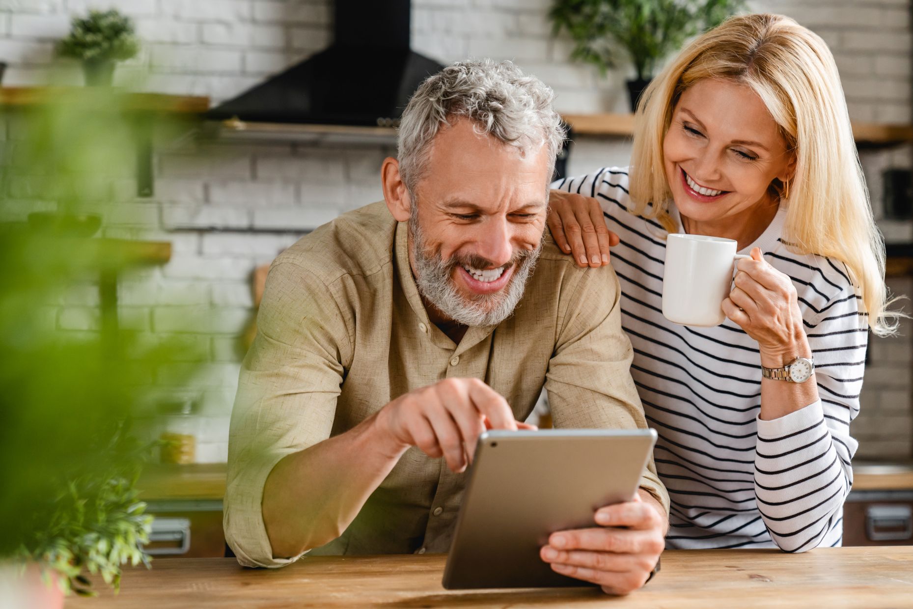 Happy senior couple using digital tablet